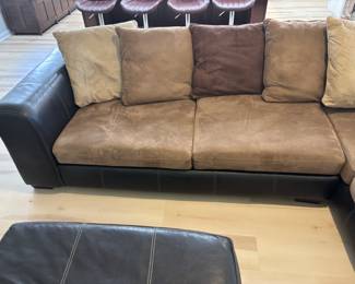 2 pc Sectional Sofa Browns faux leather and suede with ottoman. $ 450.00   (1) Sofa: 90"L 36"D 26.5"T   (2) Sofa: 80"L 36"D 26.5"T Pillow back, Ottoman: 42"x 42" x 17"