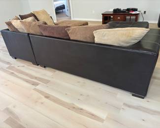 2 pc Sectional Sofa Browns faux leather and suede with ottoman. $ 450.00   (1) Sofa: 90"L 36"D 26.5"T   (2) Sofa: 80"L 36"D 26.5"T Pillow back, Ottoman: 42"x 42" x 17"