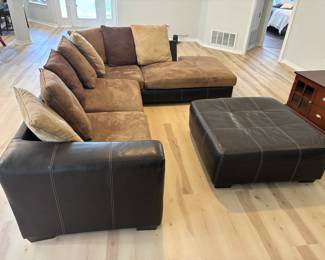 2 pc Sectional Sofa Browns faux leather and suede with ottoman. $ 450.00   (1) Sofa: 90"L 36"D 26.5"T   (2) Sofa: 80"L 36"D 26.5"T Pillow back, Ottoman: 42"x 42" x 17"