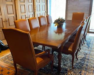 Stunning dining/conference table by Century with 8 leather side chairs and 2 captain's chairs.  Perfect condition.   Note the lovely rug it is standing on.
