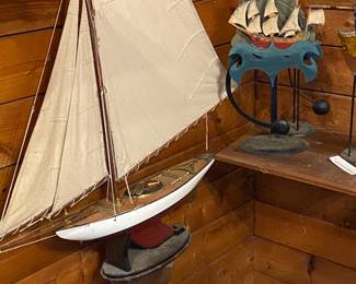 One of several model sailing ships and another kinetic balance sculpture.