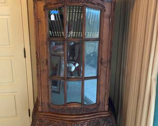 Wow!  This is a "must see".  This elaborately carved display cabinet has beveled glass on all 3 sides and has 2 lower drawers for storage.