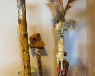 Several walking sticks and a Native American staff.