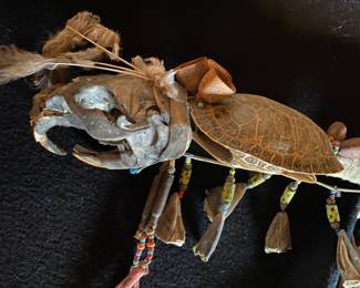 OK..here is an unusual item.  This is a rod with a turtle shell, skull head, beadwork, and other ornamentation.