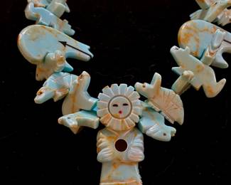 A detail of a large fetish necklace.  Picture makes it look faded but it is deep turquoise in color.