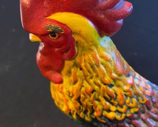 Detail of a colorful large metal rooster.