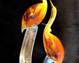 Beautiful very large art glass sculpture of exotic birds. This picture makes the birds look more orange than  is the  case.  The sculpture reflects what color is near it.  This piece is signed by the artist, but we have yet to clearly identify the signature!