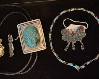 Mexican  sterling brooches, large turquoise bolo tie, sterling turquoise and onyx collar necklace, and sterling butterfly pin.