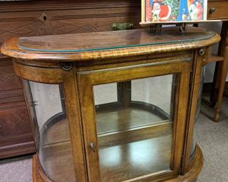 Curved glass floor cabinet