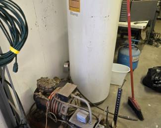 Air compressor with water heater for a tank