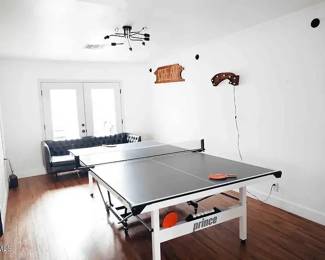 black leather couch and really nice ping pong table
