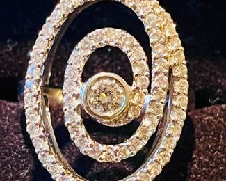 contemporary 14 karat white gold diamond swirl ring.