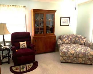 View of Burgundy Electric Lift Chair, Display Cabinet and Upholstered Twin Sleeper/Storage Ottoman