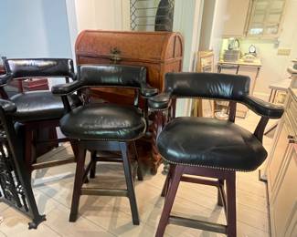 4 black leather swivel bar stools w/nailhead accents (one not pictured.)