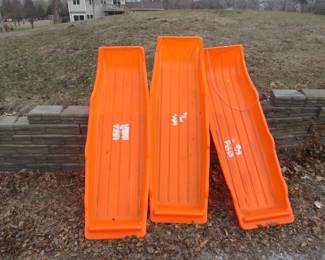 Lot 300. Three 62" plastic sleds