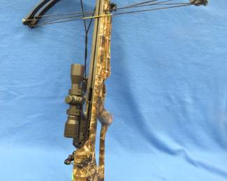 Lot 137. Barnett Quad 400 crossbow in camo with a Red Hot scope, 26 bolts, some broadheads, two quivers, and a hard bolt case.