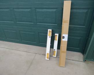 Lot 312. Two new chrome towel bars and an unopened box that we think is curtain rods