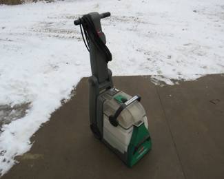 Lot 383. Bissell Big Green carpet cleaning machine. Did not power up but we weren't sure how to operate it.