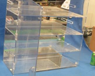 Lot 279. Pexiglass cabinet with four shelves, mirrored back and bottom, and a hinged door to keep out the dust 24"W x 24"H x 10 1/2" D