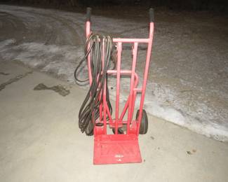 Lot 309. Heavy-duty dolly and a 20-amp locking extension cord in poor condition