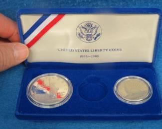 Lot 97. 1986 Proof Liberty 90% silver dollar weighing 26.73 gr., and a 1986 Proof copper/nickel half dollar. No gold coin.