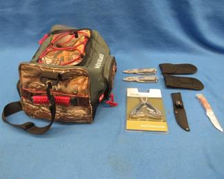 Lot 287. RMEF canvas bag with NIP Cabela's multitool, two Chart multitools, and a NRA knife