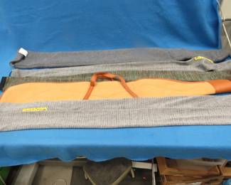 Lot 127. Five gun socks, one padded, and a canvas gun case
