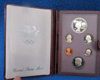 Lot 93. 1983 Olympic Prestige Set including a silver dollar containing 90% silver dollar weighing 26.73 gr.