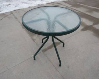 Lot 293. Patio table with a glass top. 27" diameter.