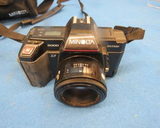 Lot 396. Minolta 35mm camera, with flash, case, and a roll of undeveloped film in the camera