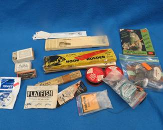 Lot 101. Vintage tackle including braided line, hook holders, weights, hooks, vintage South Bend/Oreno catalog, and more.