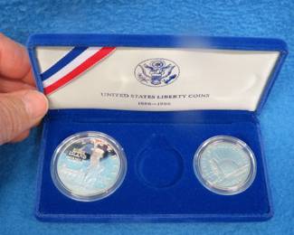 Lot 96. 1986 Proof Liberty 90% silver dollar weighing 26.73 gr., and a 1986 Proof copper/nickel half dollar. No gold coin.