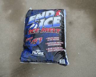 Lot 308. 50 lb. bag of ice melt. 3" on the bottom of the bag has hardened, but 80% is loose.