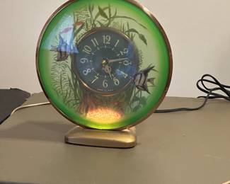 1950’s Sessions electric lighted aquarium clock. Fish “swim” around dial. Excellent condition.
