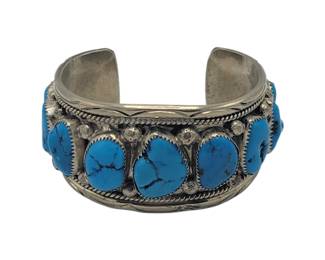Navajo 9 Stone Turquoise Bracelet

L 6.5 cm x W 5 cm (end to end)

3 cm opening

Width of band 4 cm

Weight 71.86 grams (with stones)

Estimated Melt Value: $61.03&nbsp;as of (1/8/25) (with stones)

Buyer is responsible to pay for Shipping and Ins (See Shipping Details)&nbsp;