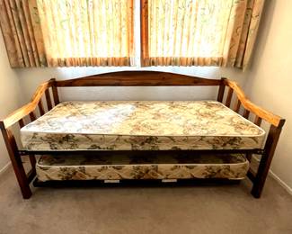 Wooden daybed with a trundle bed underneath