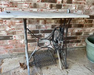 Another of 3 iron sewing machine base tables - this one on front porch