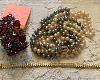 a rhinestone bangle, a tennis bracelet and a double strand 1977 Givency necklace