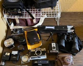 Lots of great vintage and newer cameras and lenses. Some include cases and instructions.