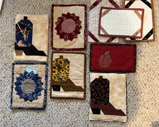 These are cute little quilting, squares, good for keeping your needles and pins on. If you turn them over, you can hold note cards inside the loops.