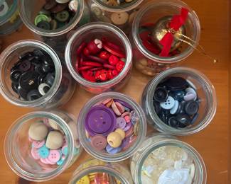 Many many sewing buttons and accessories. Bias, tape, buttons, needles, rulers, scissors, elastic, pins, hooks, just about anything you can think of that you need to sew with.!!