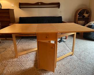 This awesome table folds down into a smaller table or it can be expanded. Also, his storage inside.