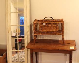 Decorative mirror. Drop leaf table. Bamboo basket.