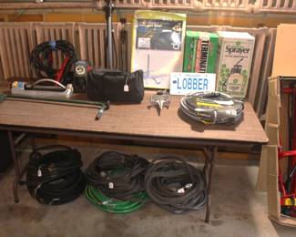Variety of hoses and misc. garden items.