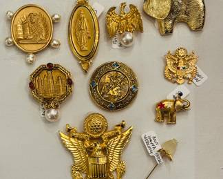 Extensive collection of Ann Hand brooches and a collar pin (lower R)