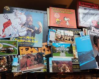 Lots of vintage post cards, maps , and books.