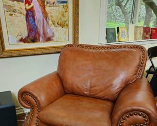 Oversize leather Chair and ottoman in saddle leather.