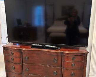 large Vizio TV and Serpentine Dresser
