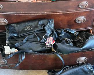 Dozens of never used purses and handbags still with original tags