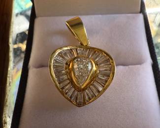 18KT CUSOM DEIGNED HEART SHAPED PENDANT WITH 1CT CENTER STONE AND CHANEL SET SURROUNDING DIAMONDS